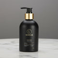 Black bottle with gold pump on a white background