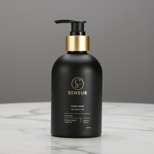 Black bottle with gold pump on a white background