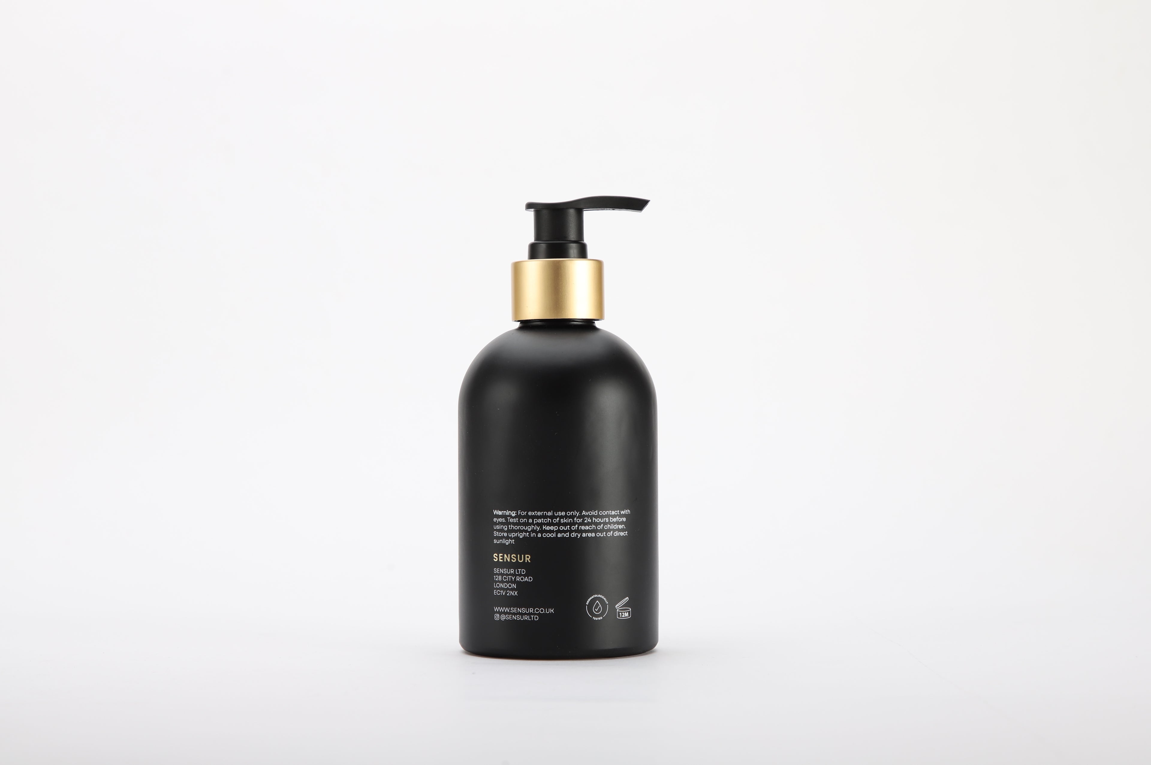 Black bottle with gold pump on a white background