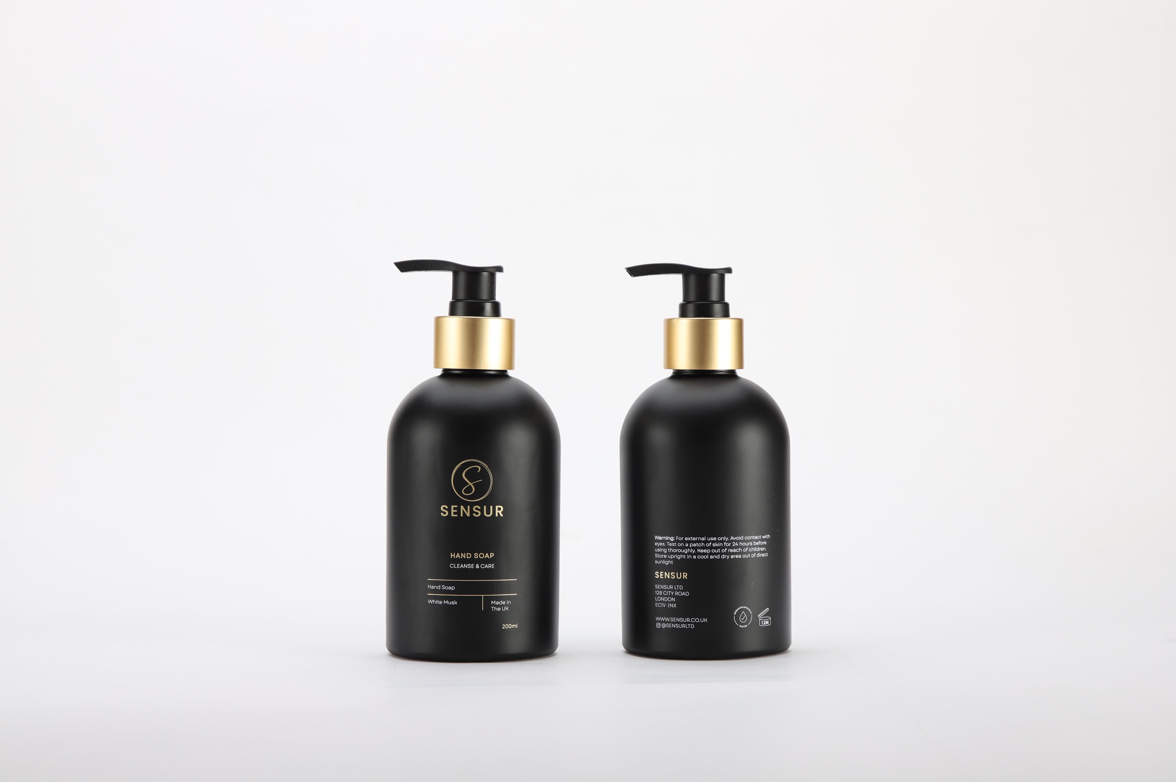 Two black bottles with gold caps on a white background