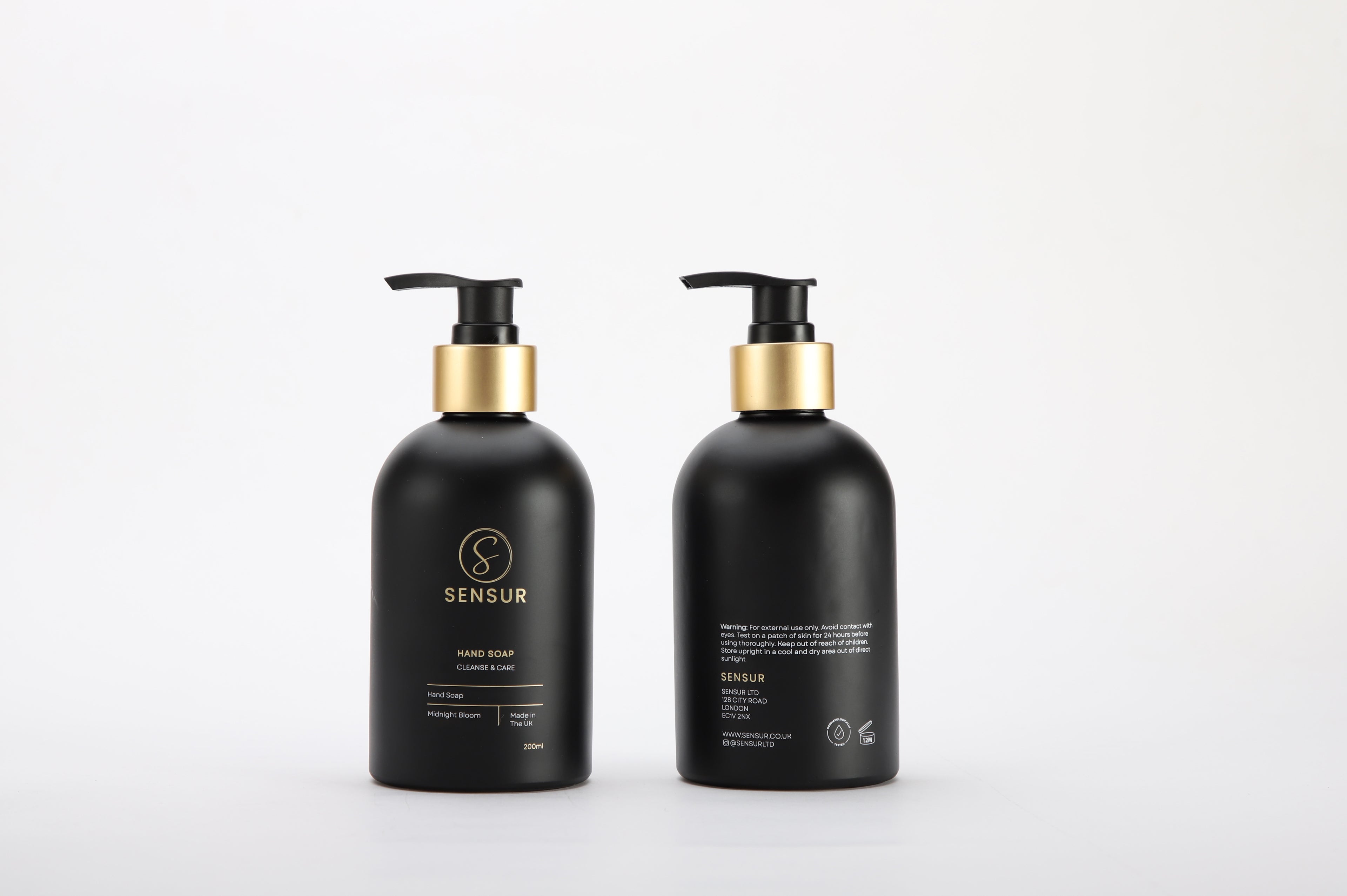 Two black bottles with gold pumps on a white background